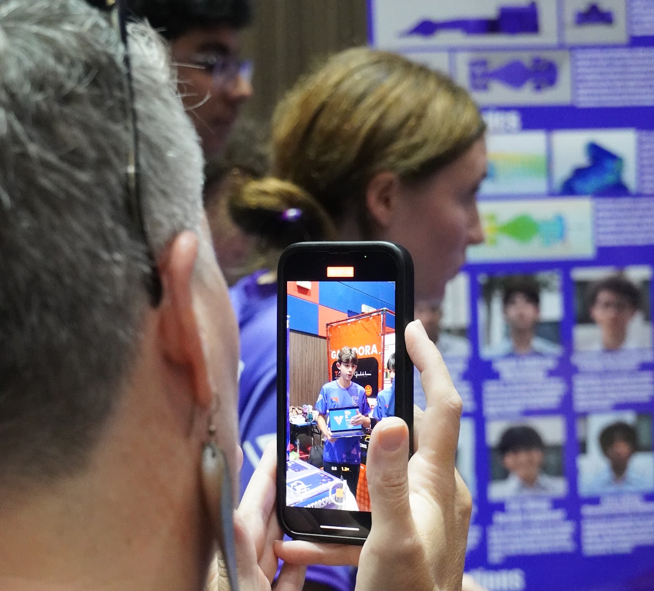 A presentation moment captured on a spectator’s phone