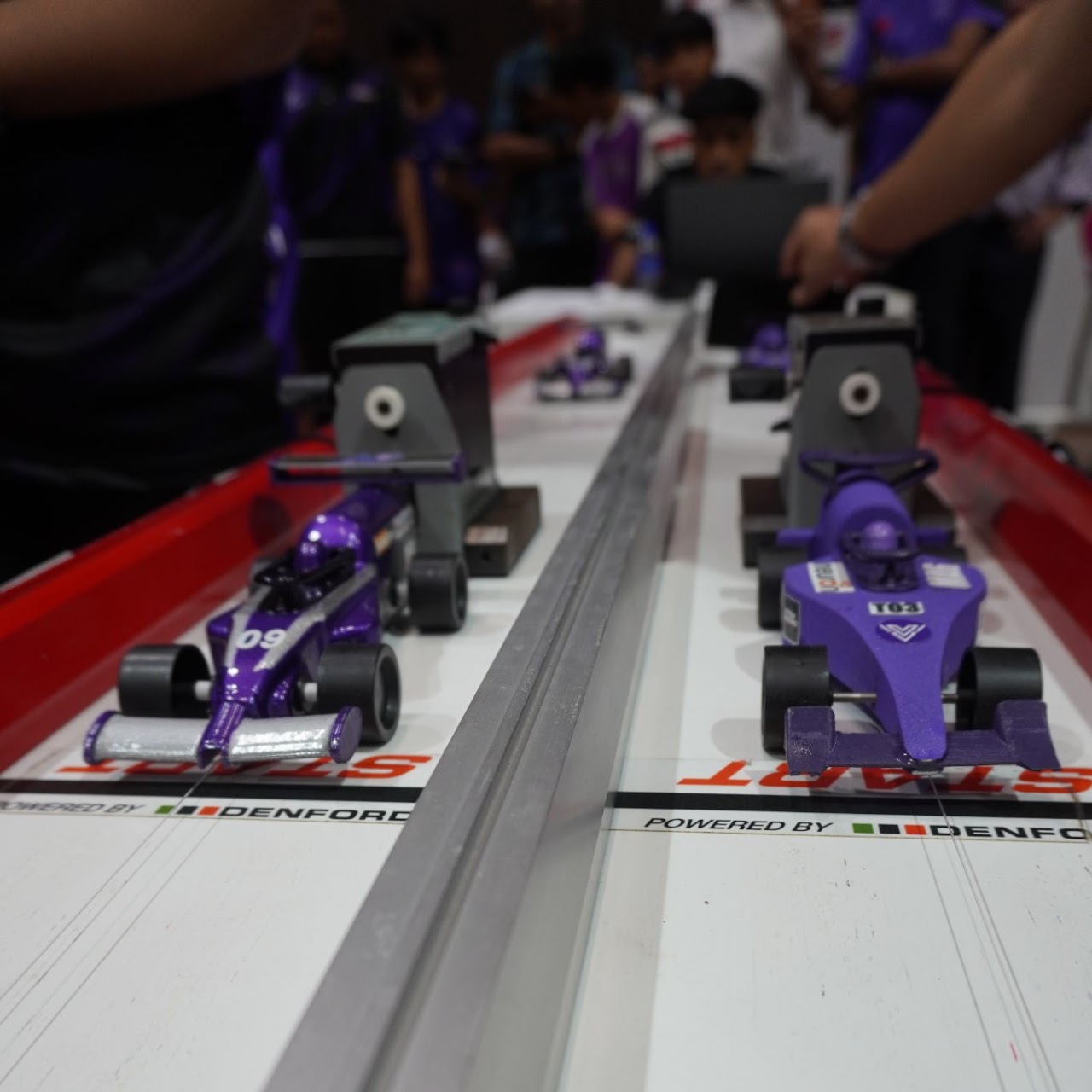 A close-up view of the race lane and competing cars