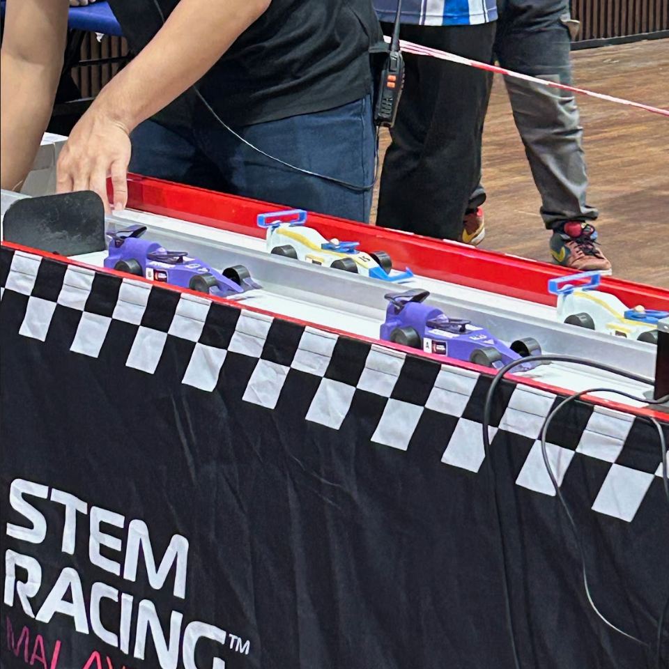 Multiple cars lined up on the STEM Racing track